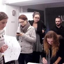 Students reading documents at a workshop in Poland.