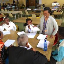 Five librarians at a table working together.