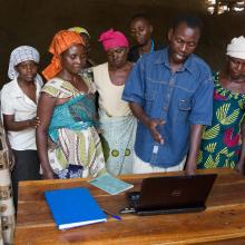 Farmers learn to use a note-book computer.