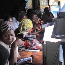 Women farmers learning how to use computers.