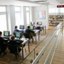 Children in 'A. & M. Miskiniai' Public Library playing the library’s educational computer game, Issukis. Photo credit Gintare Zakarauskaite.