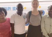 Alex Halloran with the library and teaching team in Ho: names, from the left, Seva, Charles, Alix, and David, standing in front of the library van.