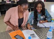 two librarians with mobile devices at digital literacy training.