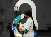 A researcher against the backdrop of the  OA lock logo