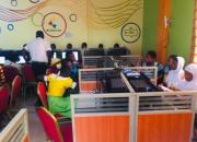 Students using computers in a library in Ghana. 