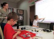 Kids assembling LEGO robots in the library