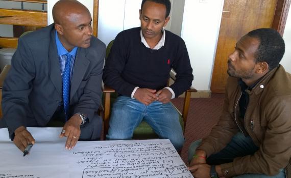 Open access policy workshop in Addis Ababa University Three men discussing the Open Access indoors