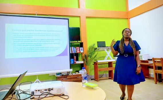 Library ICT Coordinator shares best practices for organizing school outreach programmes, using PowerPoint.