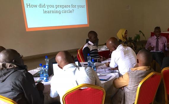 Librarians at a a desk discussing issues related to the project. 