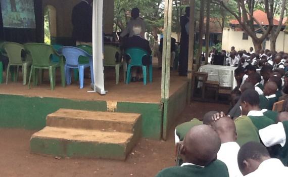 Kisumu High School pupils connect to Lions High School and Nakuru library, 200 km away. When large groups of children take part, schools use projectors to magnify images and speakers to amplify sound. Children taking part in an online inter-school debate. The children are seeing images of the other school on a big screen.