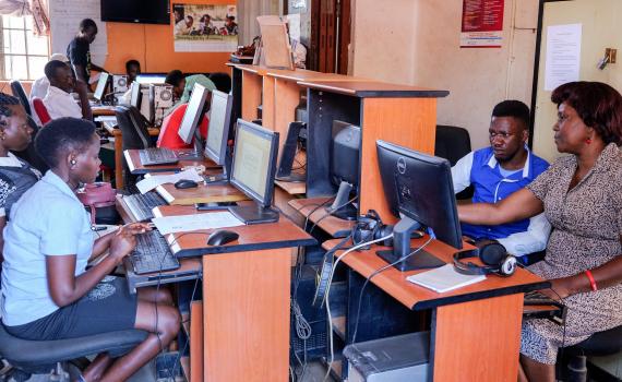 People in Mbale Public Library in Uganda, learning how to use computers. 