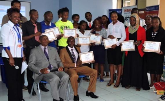 A group of learners holding certificates.