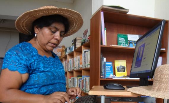Rosalinda Tay of the Lema Artisans’ Association uses the library’s computers to photograph and market her hand-made hats. Woman artist who uses the library’s computers to photograph and market her hand-made hats.