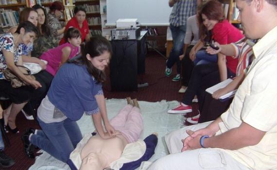 Library trainees practise using the First Aid dummy. Library trainees practise using the First Aid dummy.
