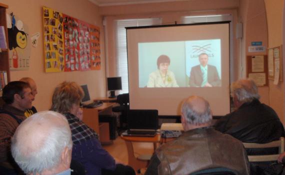 Farmers view a webinar in the library.