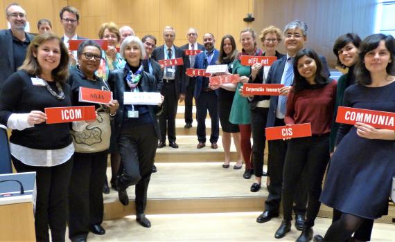 Group photo of 19 representatives from library, archive, museum and education sectors at SCCR/37. They are standing in a long line down a shallow stairs in the WIPO conference hall, holding organization name plaques. Group photo of 19 representatives from library, archive, museum and education sectors at SCCR/37. They are standing in a long line down a shallow stairs in the WIPO conference hall, holding organization name plaques.
