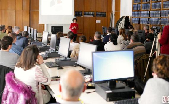 Journal editors working on computers during an EIFL-KOBSON workshop, while listening to an address by EIFL OA country coordinator in Serbia, Milica Ševkušić.